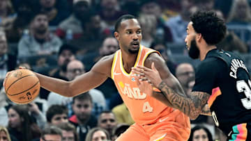 Dec 5, 2025; Cleveland, Ohio, USA; Cleveland Cavaliers center Evan Mobley (4) drives to the basket against San Antonio Spurs forward Julian Champagnie (30) during the first half at Rocket Arena. Mandatory Credit: Ken Blaze-Imagn Images