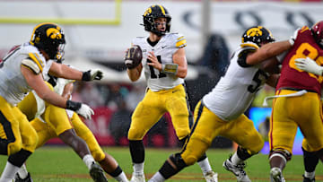 Nov 15, 2025; Los Angeles, California, USA; Iowa Hawkeyes quarterback Mark Gronowski (11) drops back to pass against the Southern California Trojans during the second half at the Los Angeles Memorial Coliseum. Mandatory Credit: Gary A. Vasquez-Imagn Images