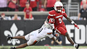 Oct 4, 2025; Louisville, Kentucky, USA; Louisville Cardinals wide receiver Caullin Lacy (5) runs the ball against Virginia Cavaliers linebacker Maddox Marcellus (11) during the second half at L&N Federal Credit Union Stadium. Virginia defeated Louisville 30-27. Mandatory Credit: Jamie Rhodes-Imagn Images