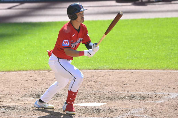 Steven Kwan watches a single he hit 