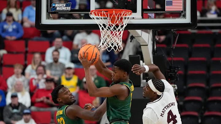 Mar 21, 2025; Raleigh, NC, USA; Baylor Bears guard Robert Wright III (1) rebounds the ball against Mississippi State Bulldogs forward Cameron Matthews (4) during the first half in the first round of the NCAA Tournament at Lenovo Center. Mandatory Credit: Bob Donnan-Imagn Images