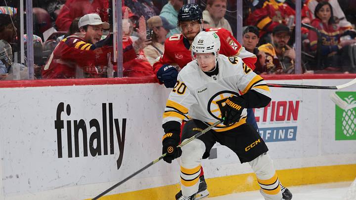 Apr 2, 2026; Sunrise, Florida, USA; Boston Bruins defenseman Henri Jokiharju (20) moves the puck against Florida Panthers left wing A.J. Greer (10) during the first period at Amerant Bank Arena. Mandatory Credit: Sam Navarro-Imagn Images