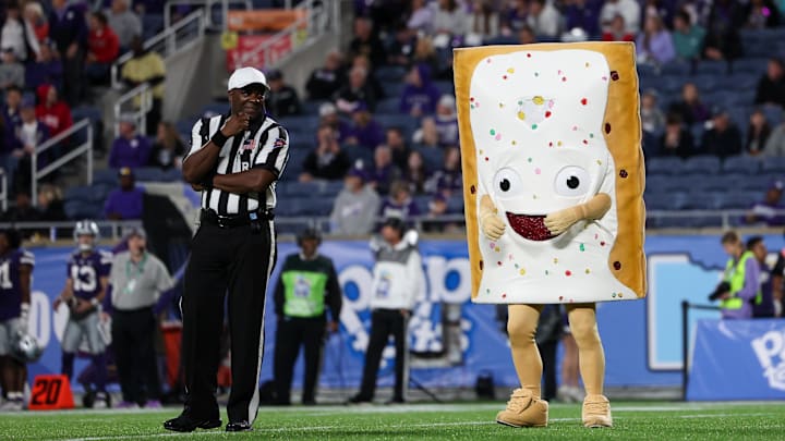 The Pop-Tarts Bowl mascot taunts a referee with deliciousness. 
