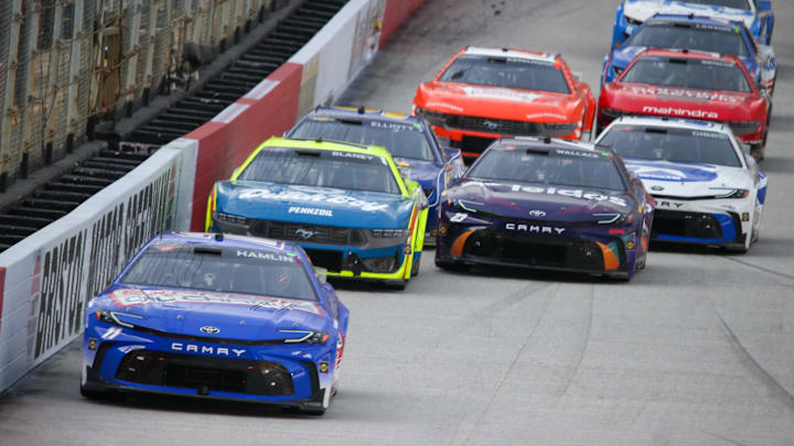 Mar 16, 2024; Bristol, Tennessee, USA; NASCAR Cup Series driver Denny Hamlin (11) leads driver Ryan Blaney (12) during the Food City 500 at Bristol Motor Speedway. 