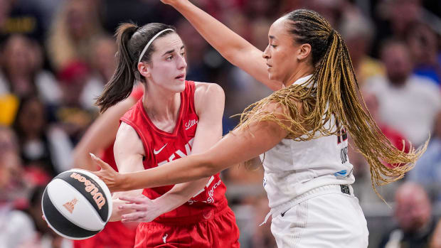 Indiana Fever guard Caitlin Clark (22) passes the ball against Atlanta Dream guard Haley Jones