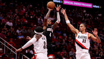 Nov 22, 2024; Houston, Texas, USA; Houston Rockets guard Jalen Green (4) shoots against Portland Trail Blazers center Robert Williams III (35) and forward Toumani Camara (33) during the second quarter at Toyota Center. Mandatory Credit: Erik Williams-Imagn Images