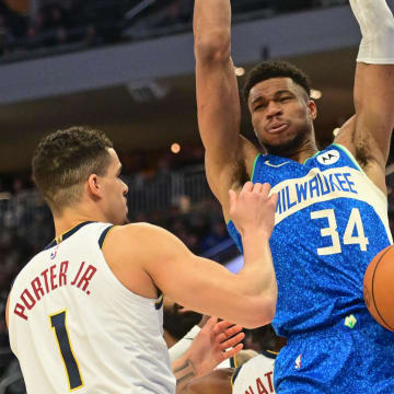 Feb 12, 2024; Milwaukee, Wisconsin, USA; Milwaukee Bucks forward Giannis Antetokounmpo (34) dunks the ball against Denver Nuggets forward Michael Porter Jr. (1) in the first quarter at Fiserv Forum. 