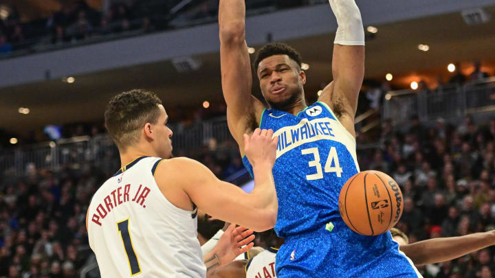 Feb 12, 2024; Milwaukee, Wisconsin, USA; Milwaukee Bucks forward Giannis Antetokounmpo (34) dunks the ball against Denver Nuggets forward Michael Porter Jr. (1) in the first quarter at Fiserv Forum. 