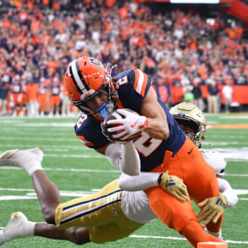 Sep 7, 2024; Syracuse, New York, USA; Syracuse Orange wide receiver Trebor Pena (2) scores a touchdown as Georgia Tech Yellow Jackets defensive back Ahmari Harvey (3) tries to stop him in the first quarter at JMA Wireless Dome. Mandatory Credit: Mark Konezny-Imagn Images