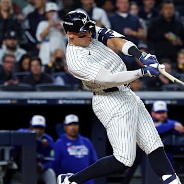 Oct 8, 2025; Bronx, New York, USA; New York Yankees right fielder Aaron Judge (99) hits a single during the first inning against the Toronto Blue Jays during game four of the ALDS round for the 2025 MLB playoffs at Yankee Stadium. Mandatory Credit: Vincent Carchietta-Imagn Images