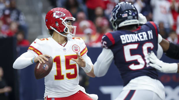 Kansas City Chiefs quarterback Patrick Mahomes (15) throws as Houston Texans defensive tackle Thomas Booker IV 