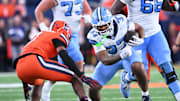 Oct 31, 2025; Syracuse, New York, USA; North Carolina Tar Heels running back Davion Gause (37) faces Syracuse Orange defensive back Demetres Samuel Jr. (1) on a run in the fourth quarter at the JMA Wireless Dome. Mandatory Credit: Mark Konezny-Imagn Images