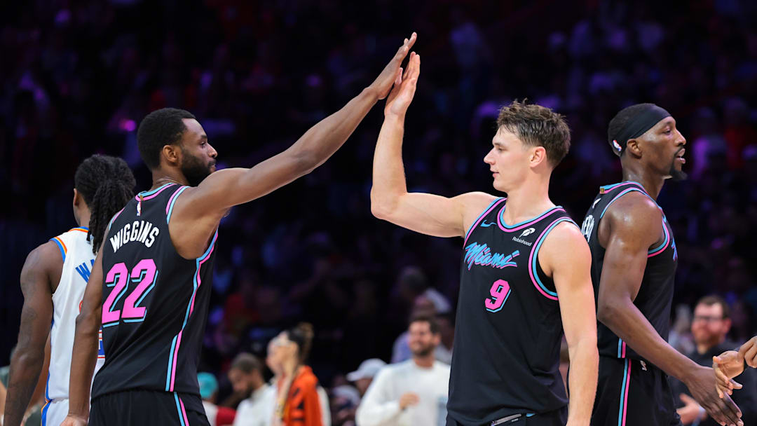 Jan 17, 2026; Miami, Florida, USA; Miami Heat guard Pelle Larsson (9) celebrates with forward Andrew Wiggins (22) against the Oklahoma City Thunder during the fourth quarter at Kaseya Center. Mandatory Credit: Sam Navarro-Imagn Images