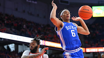 Feb 5, 2025; Syracuse, New York, USA; Duke basketball forward Maliq Brown (6) loses control of the ball on a drive as Syracuse Orange center Eddie Lampkin Jr. (44) defends during the first half at the JMA Wireless Dome. 