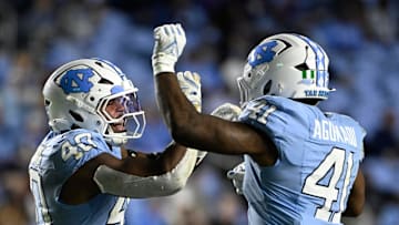 Nov 8, 2025; Chapel Hill, North Carolina, USA;  North Carolina Tar Heels linebacker Tyler Thompson (40) reacts with linebacker Jonathan Agumadu (41) after a sack in the fourth quarter at Kenan Stadium. Mandatory Credit: Bob Donnan-Imagn Images