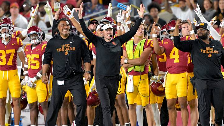 Oct 11, 2025; Los Angeles, California, USA;  USC Trojans head coach Lincoln Riley (wearing white visor) celebrates along with defensive end coach Shaun Nua after kicker Ryon Sayeri (48) hit a 54-yard field goal in the second half against the Michigan Wolverines at United Airlines Field at the Los Angeles Memorial Coliseum. Mandatory Credit: Jayne Kamin-Oncea-Imagn Images