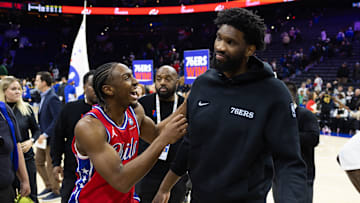 Jan 24, 2025; Philadelphia, Pennsylvania, USA; Philadelphia 76ers guard Tyrese Maxey (L) reacts with injured Joel Embiid (R) after a victory against the Cleveland Cavaliers at Wells Fargo Center. Mandatory Credit: Bill Streicher-Imagn Images