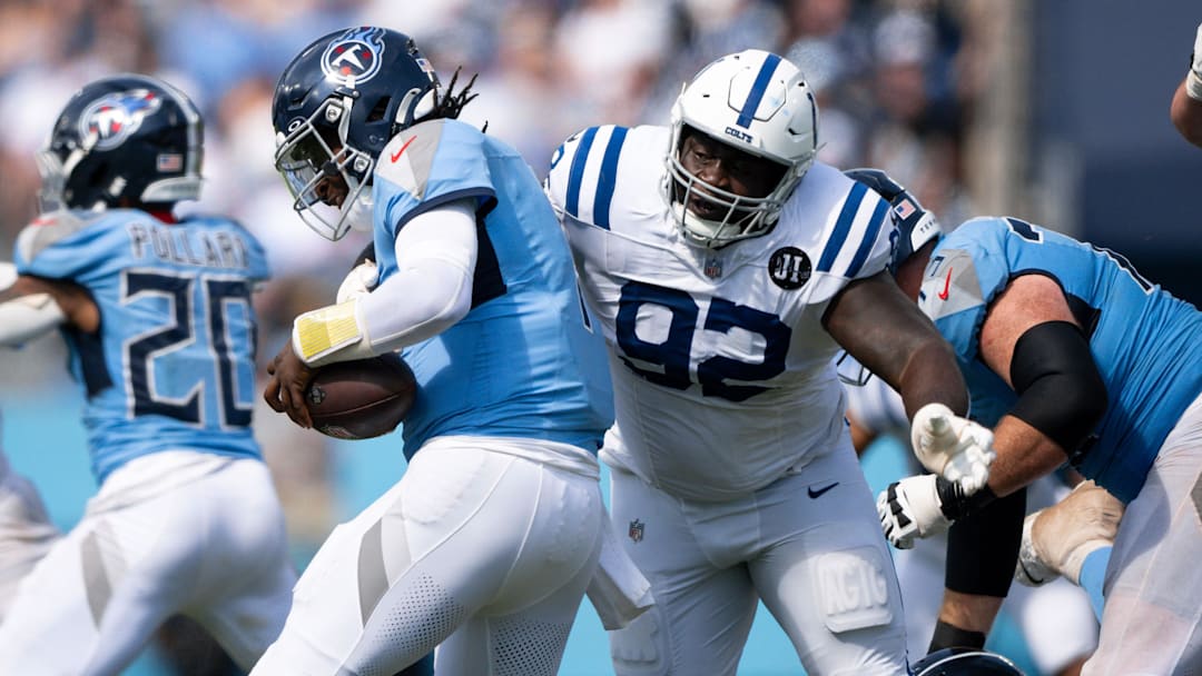 Sep 21, 2025; Nashville, Tennessee, USA;  Indianapolis Colts defensive tackle Neville Gallimore (92) sacks Tennessee Titans quarterback Cameron Ward (1) during the second half at Nissan Stadium. Mandatory Credit: Steve Roberts-Imagn Images