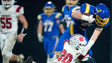 Tipton-Rosemark's Dominic Dotson (20) tries to bring down DCA's Carson Sneed (2) after a catch during their Division II-A playoff game at Donelson Christian Academy in Nashville, Tenn., Friday, Nov. 8, 2024.