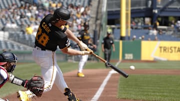 Sep 8, 2024; Pittsburgh, Pennsylvania, USA;  Pittsburgh Pirates first baseman Billy Cook (28) hits a two run double to record his first major league hit in his major league debut during the first inning against the Washington Nationals at PNC Park. Mandatory Credit: Charles LeClaire-Imagn Images