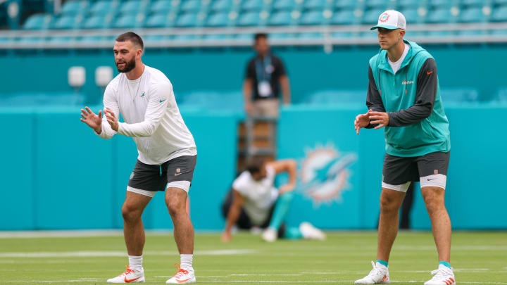 Miami Dolphins quarterback Mike White (right) and quarterback Skylar Thompson (left) warm up before the  preseason game against the Atlanta Falcons at Hard Rock Stadium.