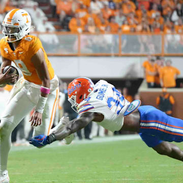 Oct 12, 2024; Knoxville, Tennessee, USA; Tennessee Volunteers quarterback Nico Iamaleava (8) runs the ball against Florida Gators edge George Gumbs Jr. (34) at Neyland Stadium. Mandatory Credit: Angelina Alcantar/USA TODAY Network via Imagn Images