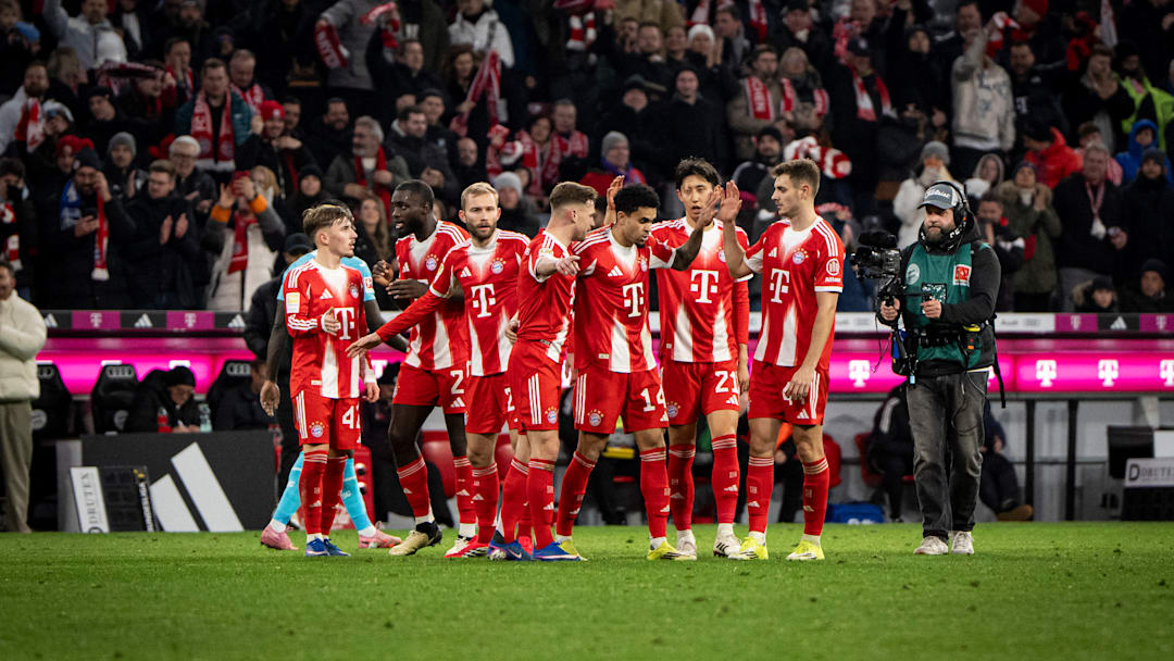 Bayern Munich players celebrating a goal against Hoffenheim.