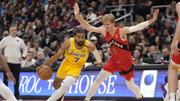Nov 1, 2024; Toronto, Ontario, CAN; Los Angeles Lakers guard Gabe Vincent (7) drives to the net past Toronto Raptors guard Gradey Dick (1) during the first half at Scotiabank Arena. Mandatory Credit: John E. Sokolowski-Imagn Images
