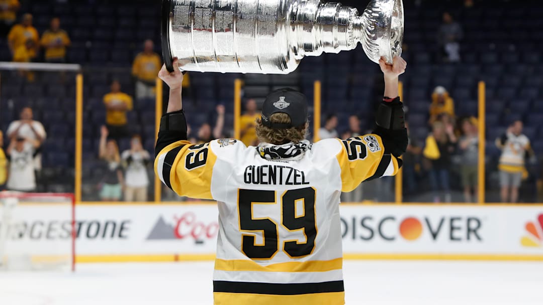 Jake Guentzel hoisting the Stanley Cup after the Penguins Game 6 victory over the Nashville Predators in the 2017 Stanley Cup Final 
