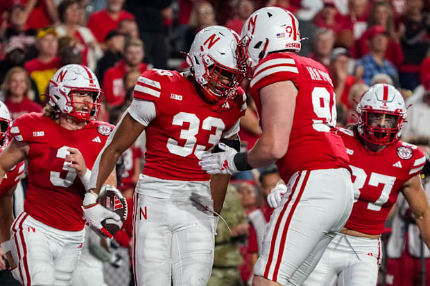 Javin Wright y el liniero defensivo Riley Van Poppel celebran después de una facturación contra los Huskies del Norte de Illinois.