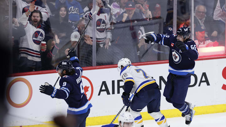Apr 7, 2025; Winnipeg, Manitoba, CAN; Winnipeg Jets left wing Alex Iafallo (9) celebrates a goal against the St. Louis Blues with Winnipeg Jets center Mark Scheifele (55) in the third period at Canada Life Centre. Mandatory Credit: James Carey Lauder-Imagn Images