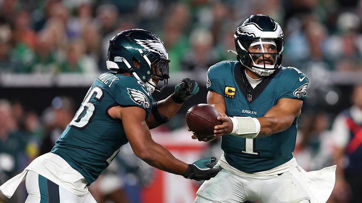 Sep 4, 2025; Philadelphia, Pennsylvania, USA; Philadelphia Eagles quarterback Jalen Hurts (1) hands off the ball to running back Saquon Barkley (26) during the third quarter of the game against the Dallas Cowboys at Lincoln Financial Field. Mandatory Credit: Bill Streicher-Imagn Images