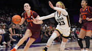 Nov 10, 2024; Charlotte, N.C.; Virginia Tech guard Carleigh Wenzel (1) tries to get past Iowa guard Lucy Olsen (33).