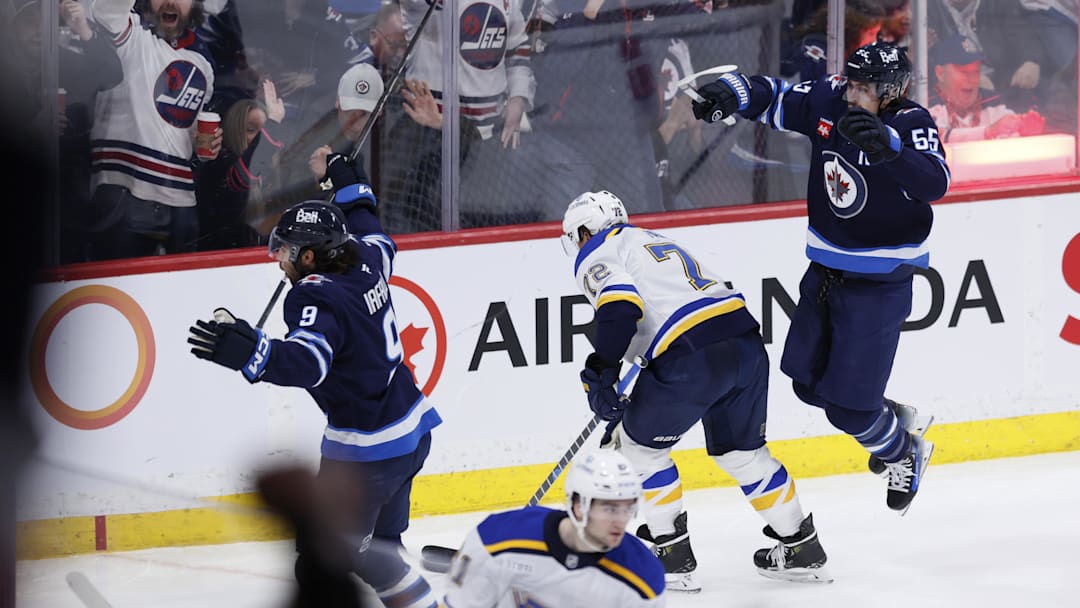 Apr 7, 2025; Winnipeg, Manitoba, CAN; Winnipeg Jets left wing Alex Iafallo (9) celebrates a goal against the St. Louis Blues with Winnipeg Jets center Mark Scheifele (55) in the third period at Canada Life Centre. Mandatory Credit: James Carey Lauder-Imagn Images