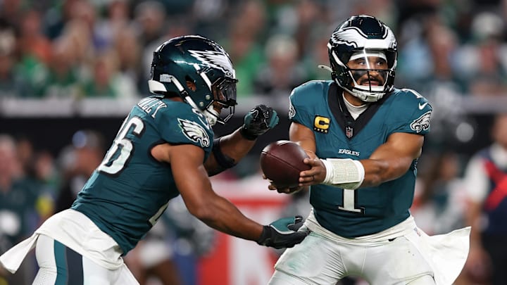Sep 4, 2025; Philadelphia, Pennsylvania, USA; Philadelphia Eagles quarterback Jalen Hurts (1) hands off the ball to running back Saquon Barkley (26) during the third quarter of the game against the Dallas Cowboys at Lincoln Financial Field. Mandatory Credit: Bill Streicher-Imagn Images