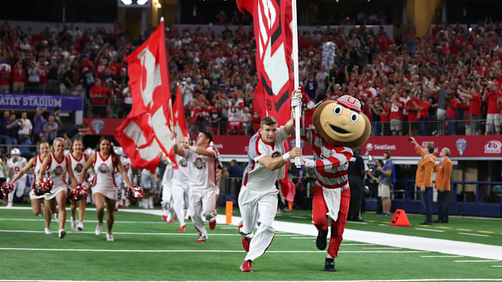 Ohio State Buckeyes mascot Brutus leads the team unto the field with the cheerleaders prior to the game at AT&T Stadium 