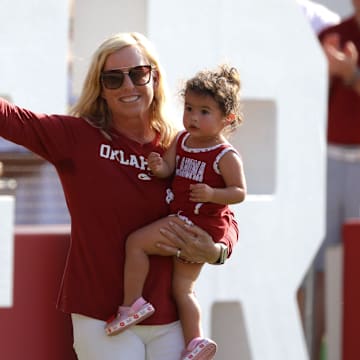 Patty Gasso holds her grandchild Grace Gasso as she is introduced during a celebration of Oklahoma Sooners fourth consecutive softball national championship at Love's Field in Norman, Okla., Saturday, June 8, 2024.