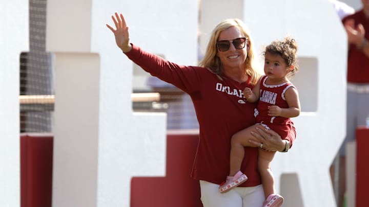 Patty Gasso holds her grandchild Grace Gasso as she is introduced during a celebration of Oklahoma Sooners fourth consecutive softball national championship at Love's Field in Norman, Okla., Saturday, June 8, 2024.