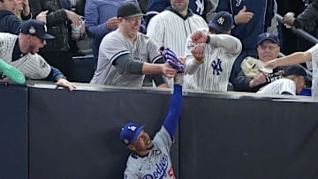 Oct 29, 2024; Bronx, New York, USA; Los Angeles Dodgers outfielder Mookie Betts (50) makes a catch in foul terriotory  against the New York Yankees in the first inning during game four of the 2024 MLB World Series at Yankee Stadium. Mandatory Credit: Robert Deutsch-Imagn Images