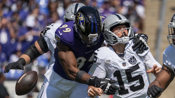 Sep 15, 2024; Baltimore, Maryland, USA;  Baltimore Ravens linebacker Odafe Oweh (99)strip sacks Las Vegas Raiders quarterback Gardner Minshew (15) during the first quarter at M&T Bank Stadium. Mandatory Credit: Tommy Gilligan-Imagn Images