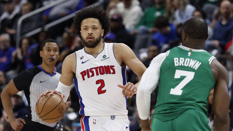 Detroit Pistons guard Cade Cunningham dribbles the ball against Boston Celtics guard Jaylen Brown.