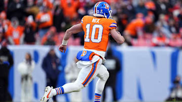 Jan 5, 2025; Denver, Colorado, USA; Denver Broncos quarterback Bo Nix (10) scrambles with the ball in the second quarter against the Kansas City Chiefs at Empower Field at Mile High. 