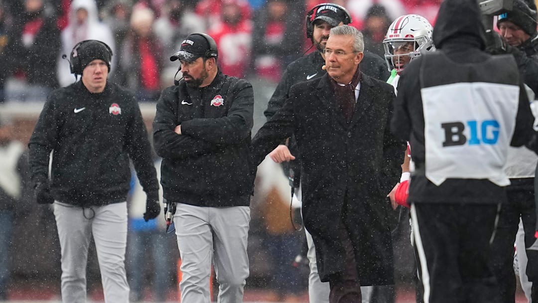 Former head coach Urban Meyer congratulates Ohio State Buckeyes head coach Ryan Day in the final moments of the NCAA football game at Michigan Stadium in Ann Arbor, Mich. on Nov. 29, 2025. Ohio State won 27-9.