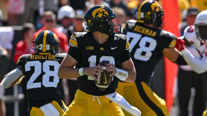 Aug 31, 2024; Iowa City, Iowa, USA; Iowa Hawkeyes quarterback Cade McNamara (12) drops back to pass during the first quarter against the Illinois State Redbirds at Kinnick Stadium. Mandatory Credit: Jeffrey Becker-USA TODAY Sports