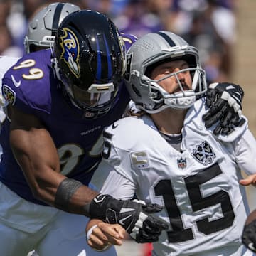 Baltimore Ravens linebacker Odafe Oweh (99) strip sacks Las Vegas Raiders quarterback Gardner Minshew (15) during the first quarter at M&T Bank Stadium. 