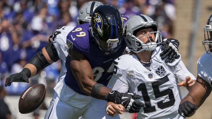 Baltimore Ravens linebacker Odafe Oweh (99) strip sacks Las Vegas Raiders quarterback Gardner Minshew (15) during the first quarter at M&T Bank Stadium. 