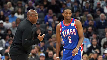 Nov 16, 2024; Sacramento, California, USA; Sacramento Kings head coach Mike Brown (left) talks with guard De'Aaron Fox (5) during the second quarter against the Utah Jazz at Golden 1 Center. Mandatory Credit: Darren Yamashita-Imagn Images