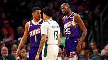 Phoenix Suns guard Devin Booker and forward Kevin Durant confront Milwaukee Bucks guard Ryan Rollins during the third quarter at Footprint Center on March 24.