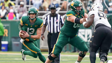 Nov 1, 2025; Waco, Texas, USA; Baylor Bears quarterback Sawyer Robertson (13) scramble against the UCF Knights during the second half at McLane Stadium. Mandatory Credit: Raymond Carlin III-Imagn Images