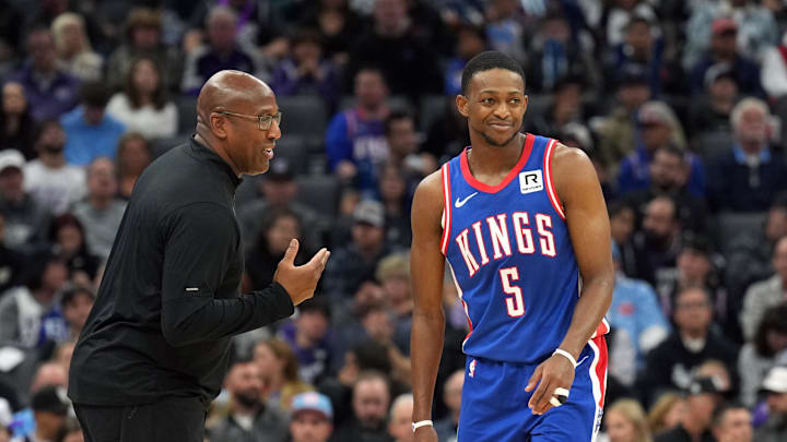Nov 16, 2024; Sacramento, California, USA; Sacramento Kings head coach Mike Brown (left) talks with guard De'Aaron Fox (5) during the second quarter against the Utah Jazz at Golden 1 Center. Mandatory Credit: Darren Yamashita-Imagn Images